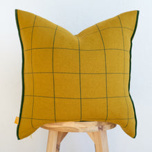 Load image into Gallery viewer, Windowpane knit pillow cover in Mustard background with dark green lines on natural wood chair