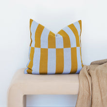 Load image into Gallery viewer, Bold striped and checkerboard cotton pillow covers in mustard and sky blue on a beige soft stool with neutral color knit throw