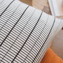 Load image into Gallery viewer, Detailed close-up of small grid pillow cover showing fine black lines and knit cotton texture