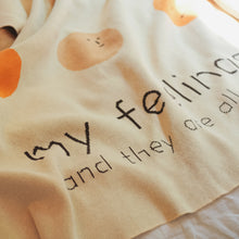 Load image into Gallery viewer, Folded view of the My Feelings kids blanket, showing the playful “my feelings and they’re all ok” text with smiling and frowning faces
