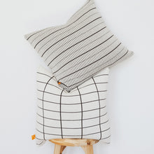 Load image into Gallery viewer, Small and medium grid cotton knit pillow covers stacked on stool to show scale difference in soft black pattern
