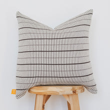 Load image into Gallery viewer, Small grid black and cream cotton knit pillow cover displayed on wooden stool against white background
