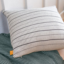Load image into Gallery viewer, Small grid pillow cover in cream and black displayed on dark green striped cotton blanket

